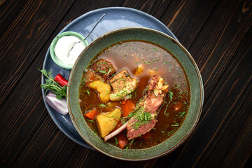Lamb Shurpa Soup with Sauce on Wooden Background