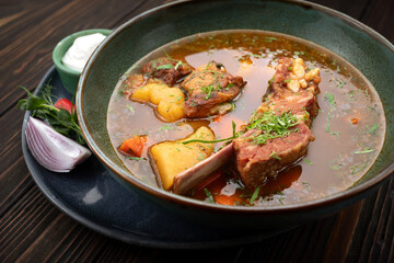 Lamb Shurpa Soup with Sauce on Wooden Background