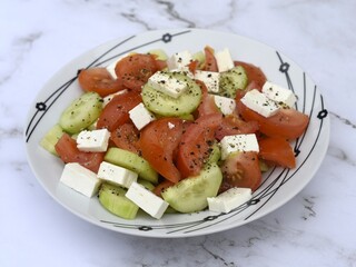 Salad made with fresh tomatoes, cucumbers and feta cheese.