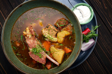 Lamb Shurpa Soup with Sauce on Wooden Background