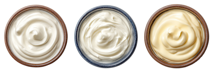 Three bowls of creamy sauces, likely condiments, in varying shades of white and light yellow