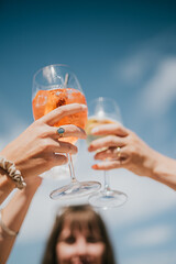 A group of people are raising their glasses to toast