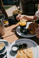 A person is eating a burger and fries at a table