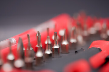 Fototapeta premium Close-up view of metal screwdriver bits arranged precisely in tool holder for easy access during repair work