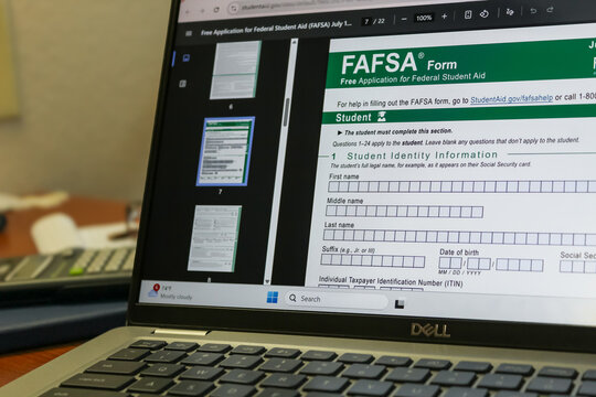 Closeup of a laptop displaying the FAFSA Form (Free Application for Federal Student Aid) and desk background. College preparation, education and technology design element. Editorial Use Only.