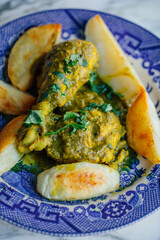 chicken cafreal with potatoes on blue and white plate