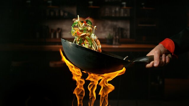 Freeze Motion of Flying Asian Wok Ingredients with Fire Flames