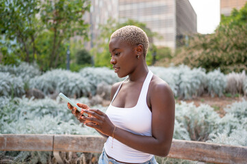 Young woman using smartphone in urban park setting