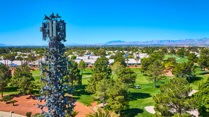 Aerial Camouflaged Cell Tower Over Golf Course and Residential Community