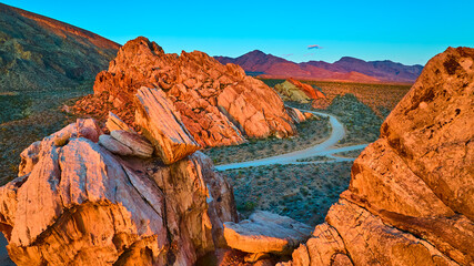 Aerial Red Rock Formations and Desert Road at Golden Hour in Nevada
