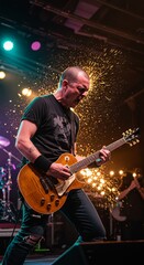 Fototapeta premium A guitarist passionately plays on stage amid light effects