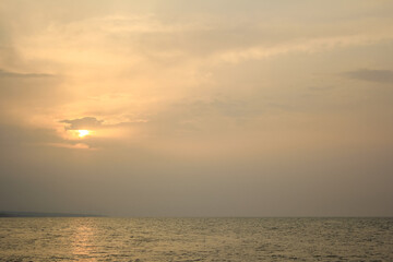 Golden sunset over the Caspian Sea in Mazandaran, Iran. Peaceful seascape with soft clouds and warm light, perfect for travel, relaxation, and nature themes.