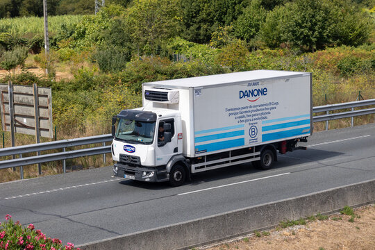 Danone branded refrigerated truck delivering dairy products on highway