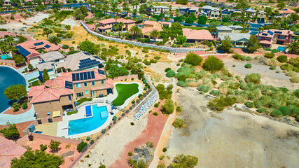 Aerial Residential Neighborhood with Pool Solar Homes and Desert Landscape