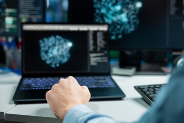 Close up of data center developer using laptop, monitoring AI systems, adjusting machine learning parameters. Server room IT professional using notebook, enhancing artificial intelligence performance