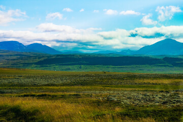 Wide Icelandic Highlands with Blue Mountains and Grassland