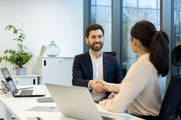Professional handshake during a business meeting in modern office setting