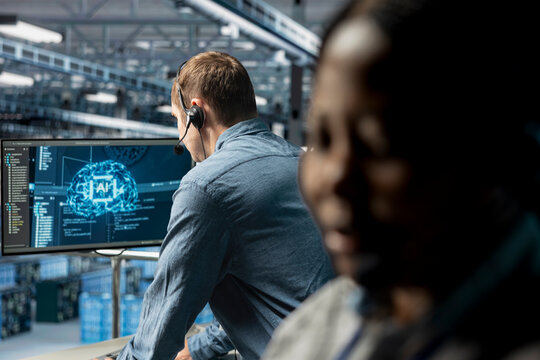 Data center expert assisting users with artificial intelligence enhanced troubleshooting, delivering technical support. Man in server farm chatting in headset mic with users in need of assistance
