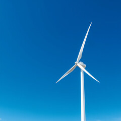Wind turbine on blue sky background