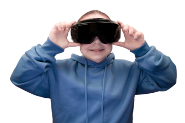 A young girl in a blue hoodie, holding and adjusting a black VR headset over her eyes with an excited smile on a transparent background