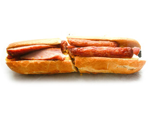 Traditional tasty Irish breakfast roll with white bread, sausage, bacon or rasher, fried egg and black pudding on greasy wrapping paper. Popular high calorie meal in Ireland. Classic dish