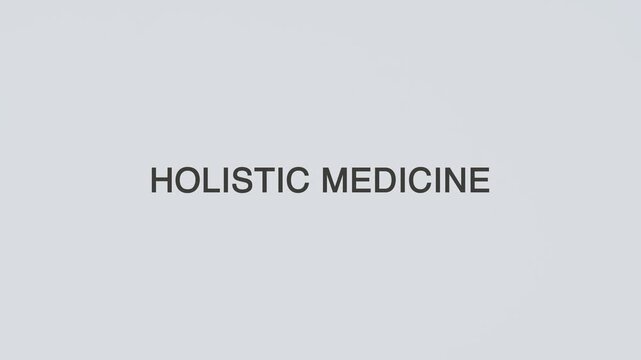Holistic medicine concept word hand holding stethoscope on white background for patient wellness, integrative treatment, prevention, monitoring, and overall health awareness