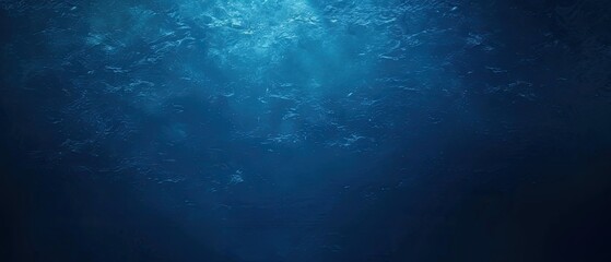 Obraz premium Underwater sunlight beams through ocean water, dark deep background, marine life backdrop