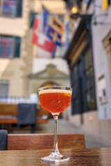A refreshing cocktail topped with foam at an outdoor cafe in Zurich, Switzerland