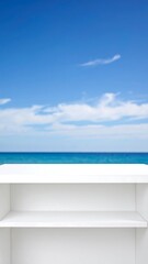 Fototapeta premium Empty white shelves against a vibrant blue sky and ocean