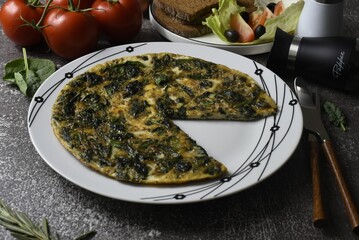 Image of omlette with young spinach.