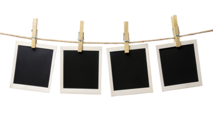 Four blank instant photo frames hanging on a rope