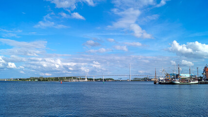 Fototapeta premium Rügen Bridge photographed from a distance under a blue sky with few clouds – scenic view of the Baltic Sea connection in Germany.