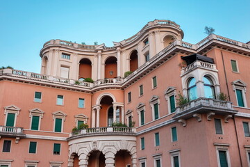 Obraz premium Ornate Mediterranean villa with curved facade, arches and decorative balconies
