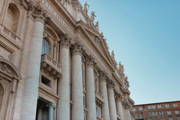 Detailed facade of St. Peter's Basilica showing classical columns and papal inscriptions