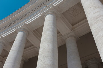 Dramatic upward view of Vatican colonnade columns with classical Doric architecture