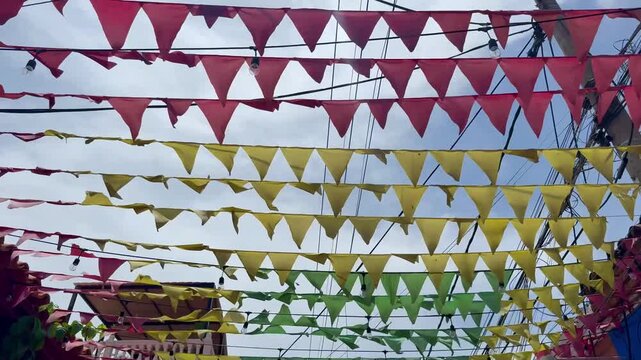 Colorful flags waving in the wind above a Colombian street in artistic Getsemani district