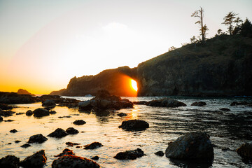 Scenic view of Second Beach at sunset in Olympic National Park, Washington State. Dramatic sea stacks, golden sky, and peaceful waves along the rugged Pacific Northwest coast.