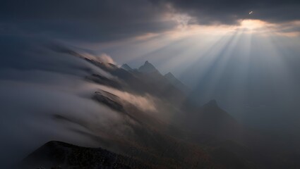 Dramatic Sunlight Piercing Through Mountain Mist and Clouds