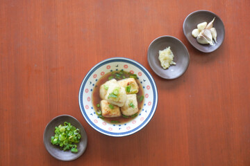 Agedashi Tofu is a spicy fried tofu dish from Japan. Silken tofu or silken bean curd, kinugoshi, is diced and then sprinkled with potato starch or cornstarch.