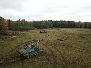 Fototapeta premium Aerial view of two PzH 2000NL artillery systems positioned in autumn field