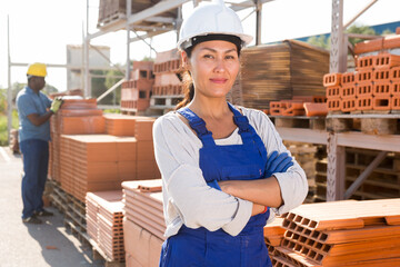 Portrait of a confident asian woman worker in the warehouse of a building materials store