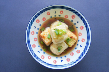Agedashi Tofu is a spicy fried tofu dish from Japan. Silken tofu or silken bean curd, kinugoshi, is diced and then sprinkled with potato starch or cornstarch.