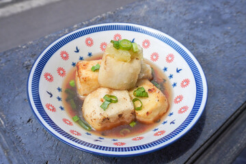 Agedashi Tofu is a spicy fried tofu dish from Japan. Silken tofu or silken bean curd, kinugoshi, is diced and then sprinkled with potato starch or cornstarch.