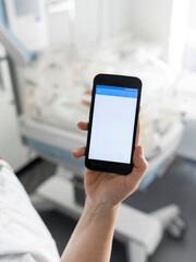 Healthcare worker using smartphone application in hospital environment for clinical management