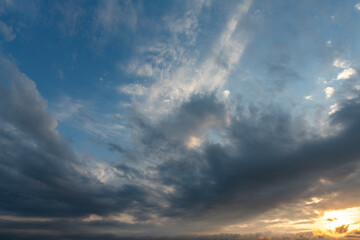 Evening sunset sky background with bright dramatic clouds.