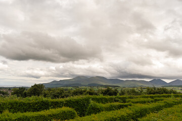 A cloudy sky with mountains in the background