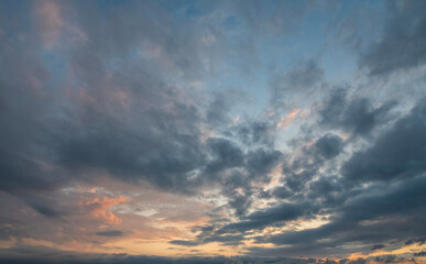 Evening sunset sky background with bright dramatic clouds.