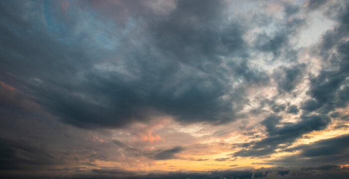 Evening sunset sky background with bright dramatic clouds.