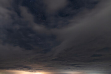 Beautiful starry sky with clouds in the night. Night sky background.