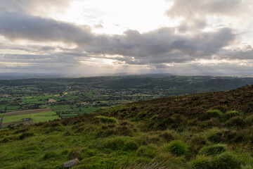 A cloudy sky with a sun shining through the clouds